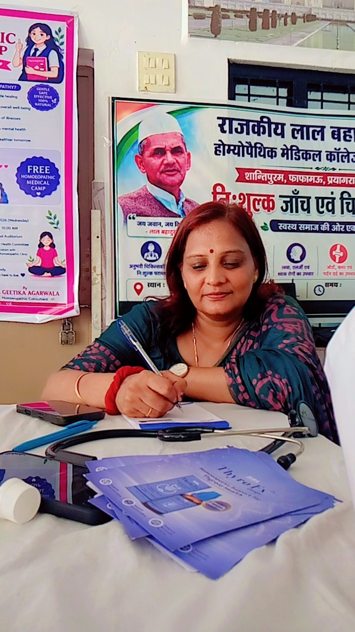 Dr. Geetika Agarwal writing notes during a patient consultation at the medical camp